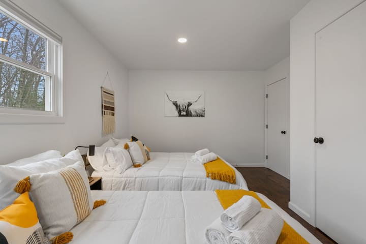 Downstairs Bedroom: Bright retreat with twin queen beds and stylish decor for ultimate comfort!