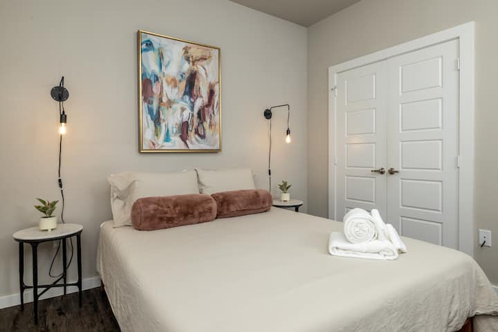 Stylish second bedroom featuring a queen bed and elegant Art Deco pendant lights on each side—designed for comfort with a touch of glamour. This bedroom is located upstairs.