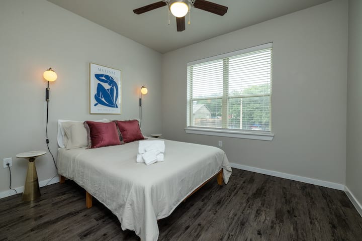 Bright and airy primary bedroom with a cozy queen bed, flooded with natural light—your perfect retreat for rest and relaxation. This bedroom is located on the first floor.