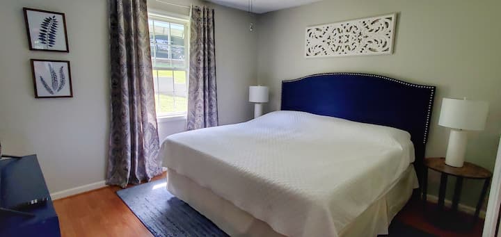 Bedroom 2 with tempur-pedic king mattress, tv, and blackout drapes