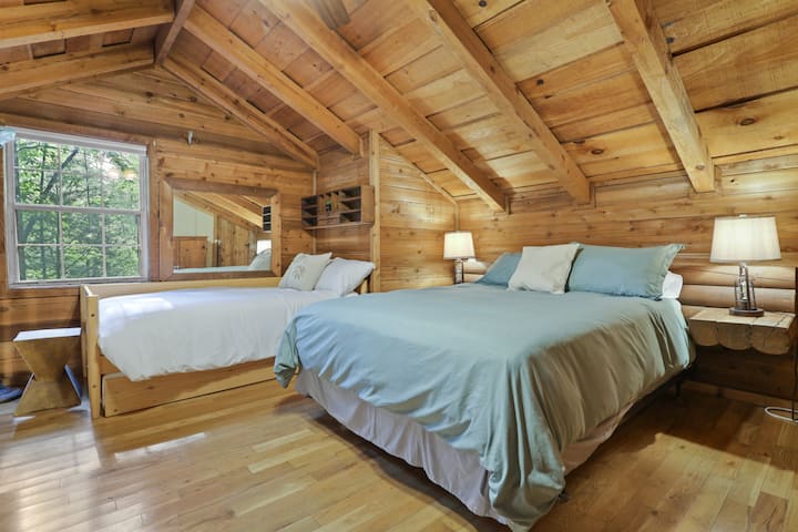 2nd bedroom is lofted on the second floor with a queen bed, twin bed, and twin trundle bed.