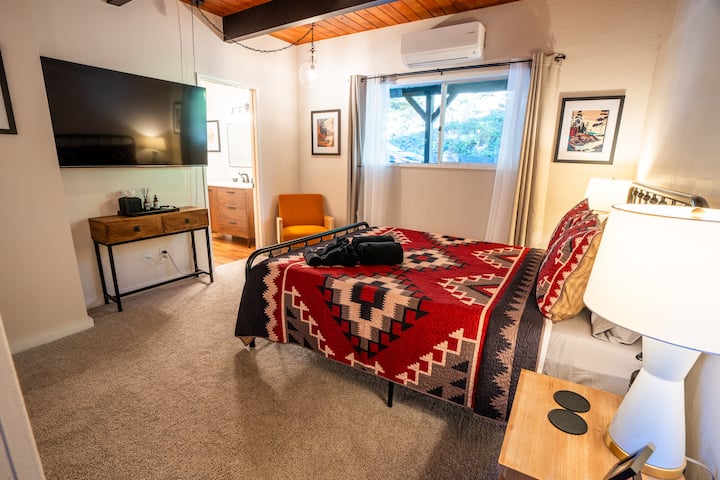 Master bedroom with AC unit, large flat screen TV, and direct access to bathroom. Located on the main level of the cabin (2nd level). 