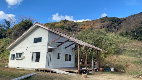 The sea is right in front of you. A house on a vast property. There is a BBQ set, pizza oven, and te