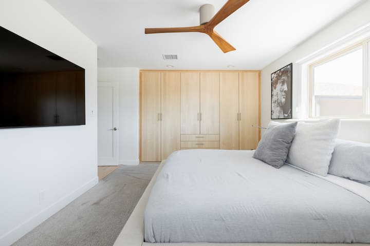 Master suite, features an en suite bathroom, & 65" Samsung smart TV, & lots of clothing storage.