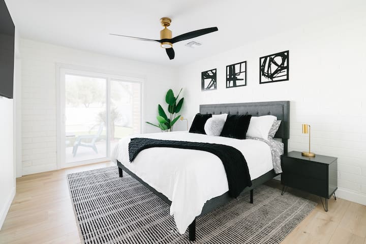Bedroom #2 features a king sized bed & sliding glass door to the backyard.