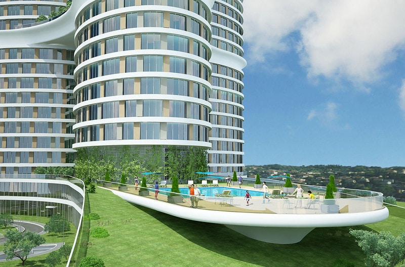 The modern building features curved architecture with expansive glass windows. An outdoor pool area is visible, surrounded by greenery and lounge spaces. Residents can be seen enjoying the amenities, creating a lively atmosphere against a backdrop of an open sky.