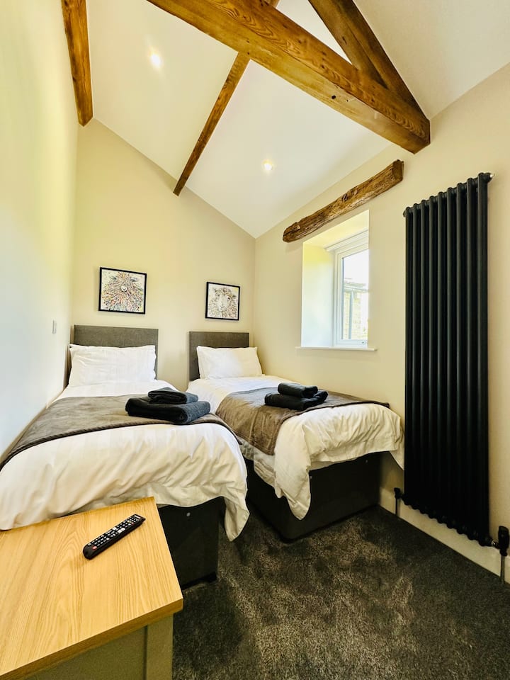 Second bedroom with two single beds and views across the fields to the rear
