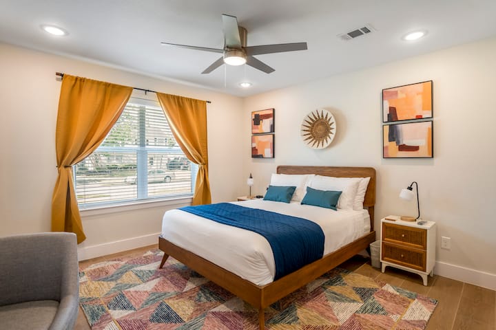 Downstairs Bedroom with Queen Bed thoughtfully designed to offer comfortable accommodations  such as a desk and chair, personal television, private well-appointed ensuite bathroom and walk-in closet.