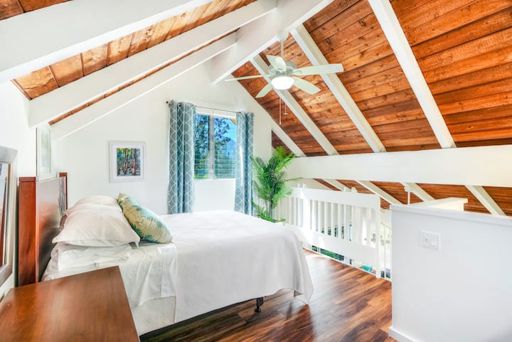 Relaxing loft space with fan for comfort.