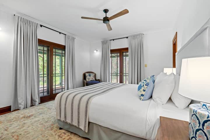 Master bedroom with fans and aircon.  Fully screened and view out to the garden.  Wake up to the sound of birds in the morning.