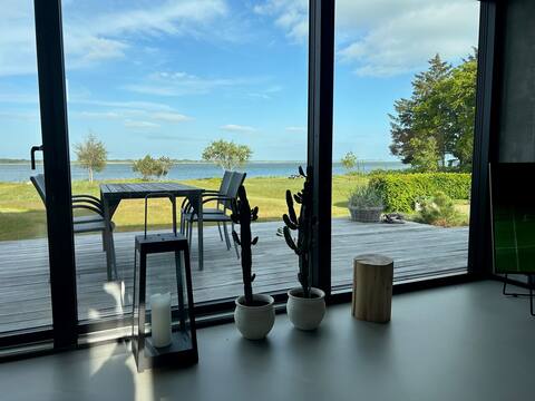 House near fjord and beach