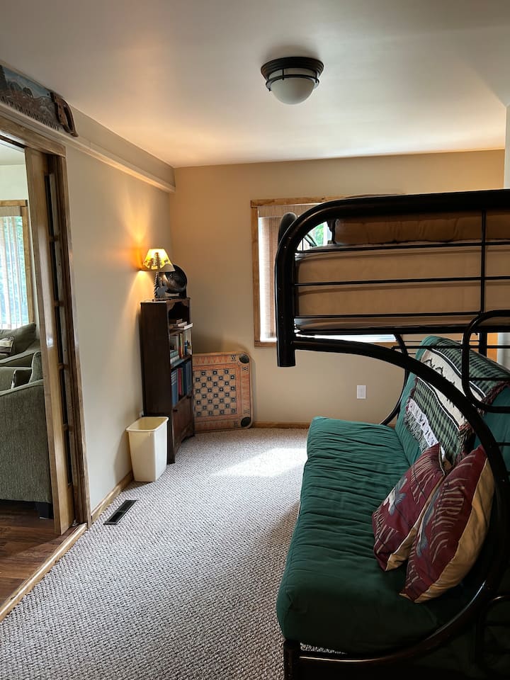 Den with a futon and upper single bed