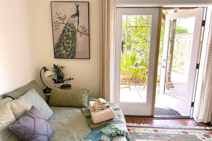 Secondary bedroom with comfortable futon sofa-bed and semi-private backyard patio