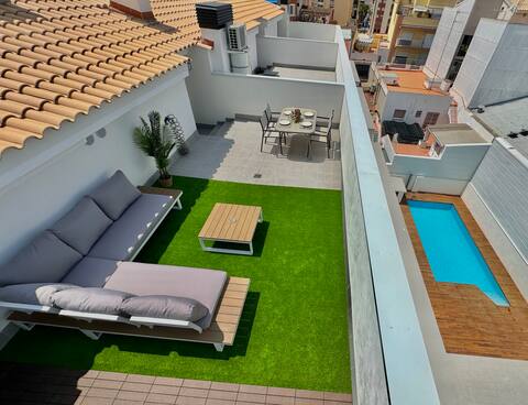 A duplex penthouse with a private terrace and swimming pool