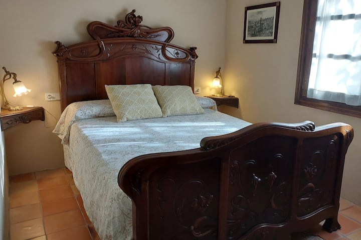 This is the bedroom downstairs. The wooden bed is Modernist style as well as nightstands lamps.
