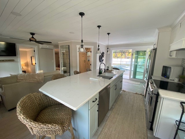A bright kitchen is featured, equipped with modern appliances including a stove, oven, and microwave. An extra-large island with seating is centered, complemented by natural light flowing through sliding glass doors that lead to an outdoor area.