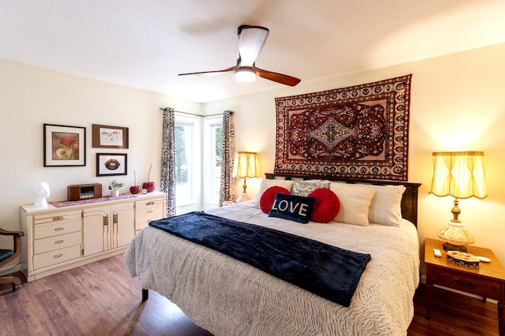 The primary bedroom featuring a king sized bed (incredibly comfortable!), private bathroom, and 42in ROKU Smart TV.  