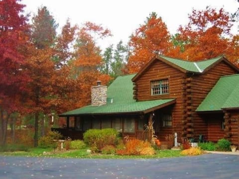 Exceptional log home on 9+ acres with lake access