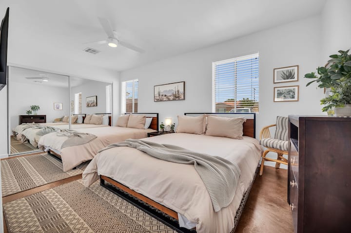 This is a very spacious bedroom fitted with two queen beds. This is labeled as bedroom 4. 