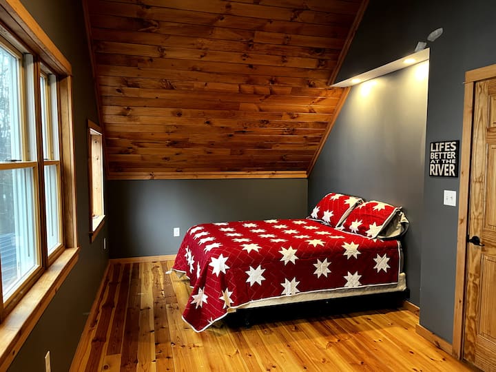 Master bedroom on second floor with a waterfront view of the Lake of the Isles - queen bed.