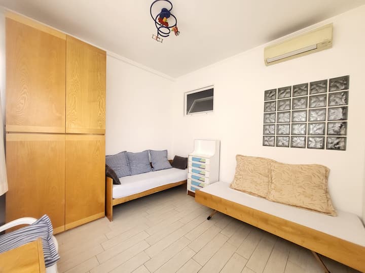 غرفة واسعة ومشرقة للغاية مع سريرين مفردين مفروشين بالكامل. نافذة كبيرة مع ناموسية وتكييف هواء.