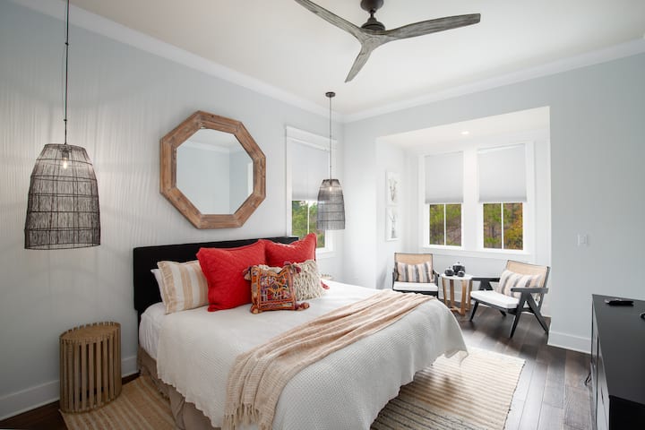 You're going to love the design of this bedroom - King bed with luxury sheets, seating area, large smart TV, dresser, spacious closet & remote-controlled fan. Windows overlook nature area.