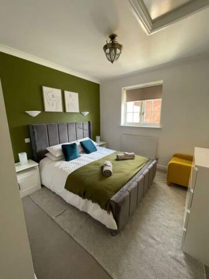 Duerme profundamente en el dormitorio 1, con una cama tamaño king con sábanas y toallas limpias, un cómodo sofá y obras de arte acogedor para completar tu descanso.