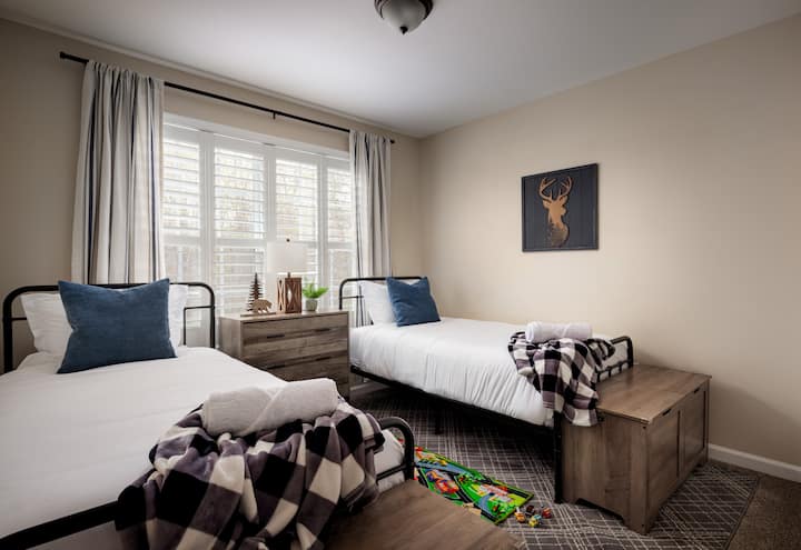 Double the fun in our twin sized bedroom. Your perfect stay equipped with benches which double as storage bins. We offer a whimsical night light which is stashed in the middle chest, and privacy curtains. 