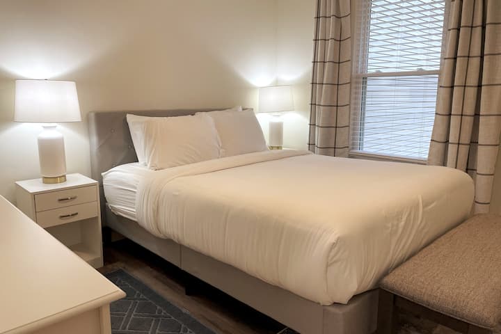 Bedroom 2 with queen bed. The bench at the foot of the bed can be used at the dining table for additional seating.