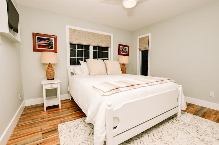 Chumba cha 2 cha kulala kwenye ghorofa kuu kina kitanda cha ukubwa wa malkia chenye starehe kilicho na godoro la kifahari na matandiko. Vivuli vya kuweka giza kwenye chumba, feni ya dari na kabati hukufanya ujisikie nyumbani. 