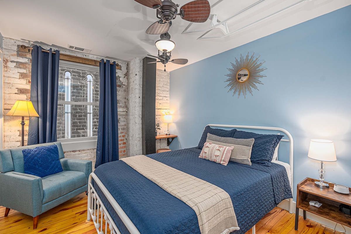 The first bedroom has a super comfy queen bed, tons of closet storage, and a desk area for putting on makeup or getting a little work done.