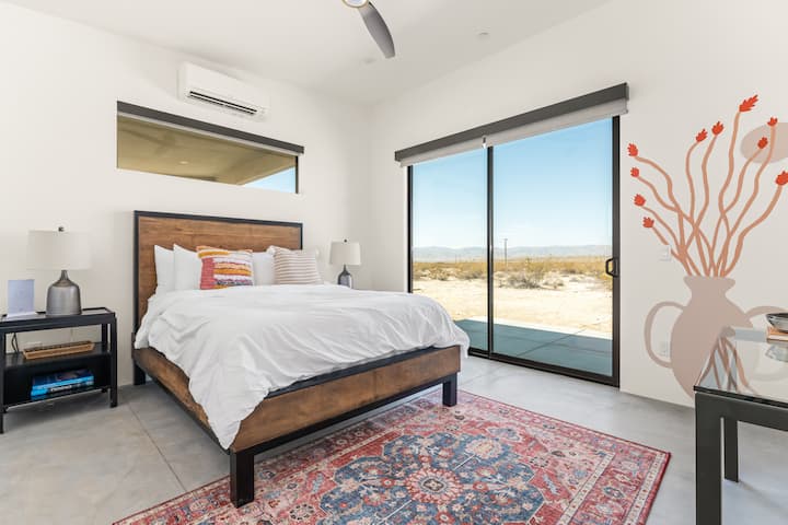 Secondary bedroom with boho inspired mural and attached private bathroom