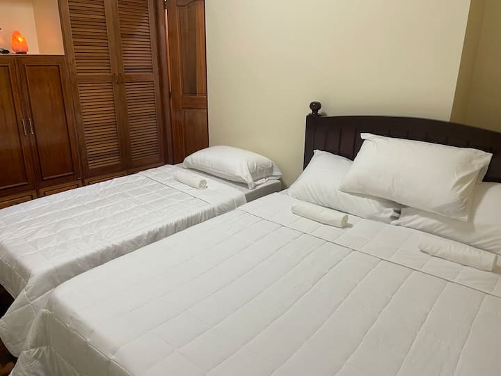 Bedroom 1, the master bedroom, offers a king bed, a single bed, and an en-suite full bathroom.