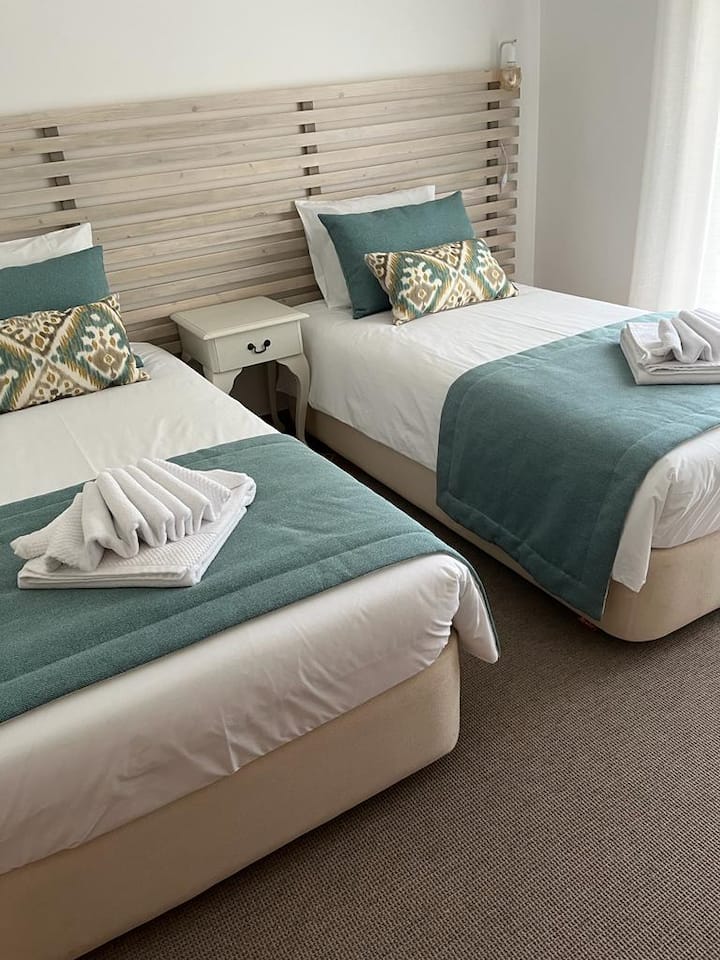 First floor two single beds bedroom with direct access to the gardens, closet, and working station