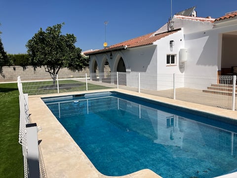 A villa with a pool and barbecue