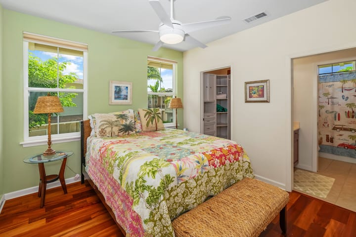 At the other end of the hallway features the other two bedrooms, bathroom, walk in closet, and private lanai.  This first bedroom offers the walk-in closet and its own sink (shared toilet and shower). Same high-quality bedding and towels! 