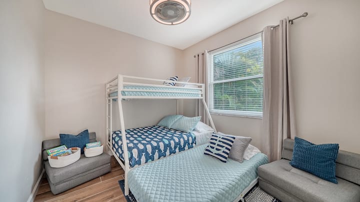 Welcome to the kids' bunk bedroom! It's a playful haven with a cozy twin bed over a double bed, complete with a trundle twin bed. And wait, there's more! Two fold-down single beds magically appear for extra giggles and bedtime stories.