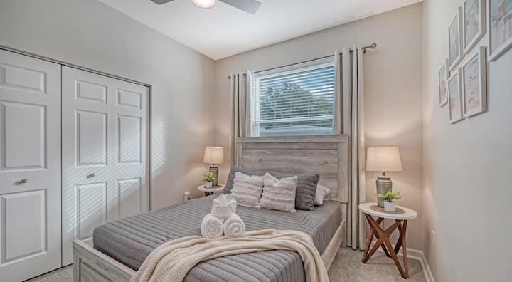 Guest Bedroom #1: Escape to our tranquil guest bedroom with a comfortable Queen bed, ceiling fan, Smart TV, and room-darkening drapes, creating a calming and serene retreat away from the bustling poolside family fun.