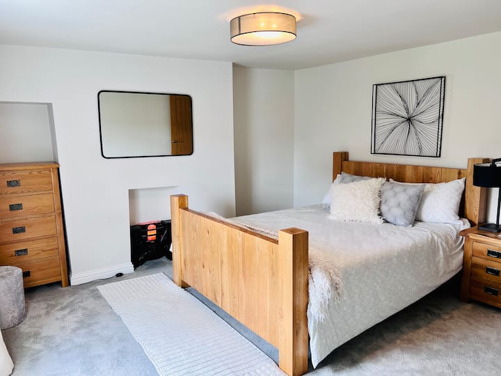 Primary bedroom with king sized bed and ensuite.