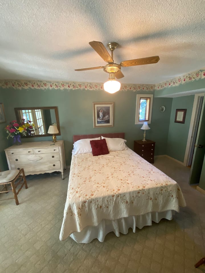 Ground level bedroom. Queen bed with adjoining bathroom and sunroom .