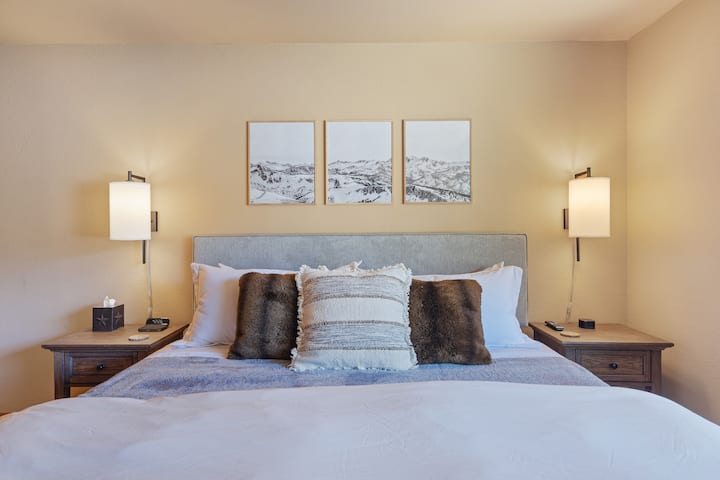 Large downstairs master bedroom with king-size bed, view of the mountain, and ample room for a pack and play