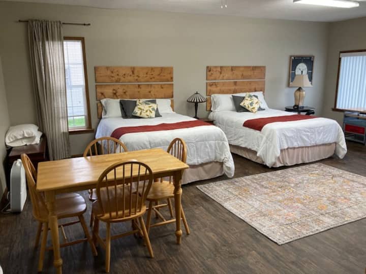 We feature two queen sized beds and a table and chairs.