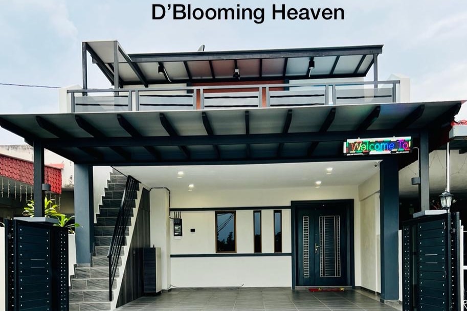 The exterior of a modern two-story home is displayed, showcasing a sleek design with a covered porch and a welcoming sign. Stairs lead to an upper balcony, while large windows allow natural light to fill the interior space.
