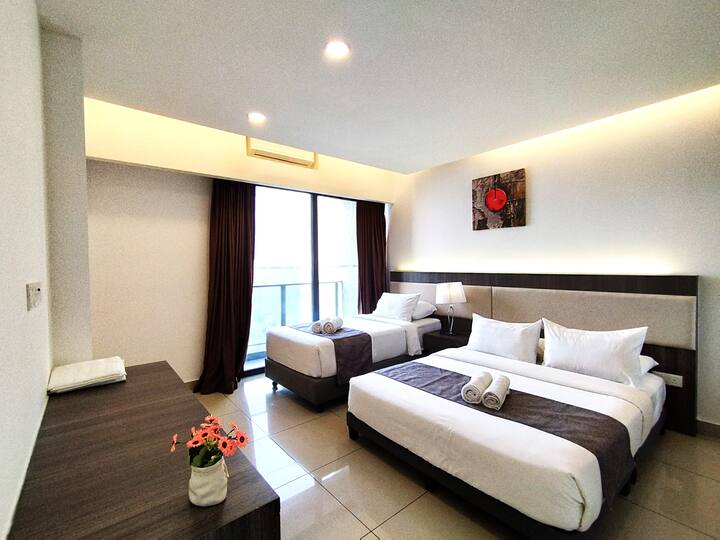 Deluxe Bedroom with 1 Queen Bed, 1 Super Single Bed, Aircon, Wardrobe with Iron & Iron Board.