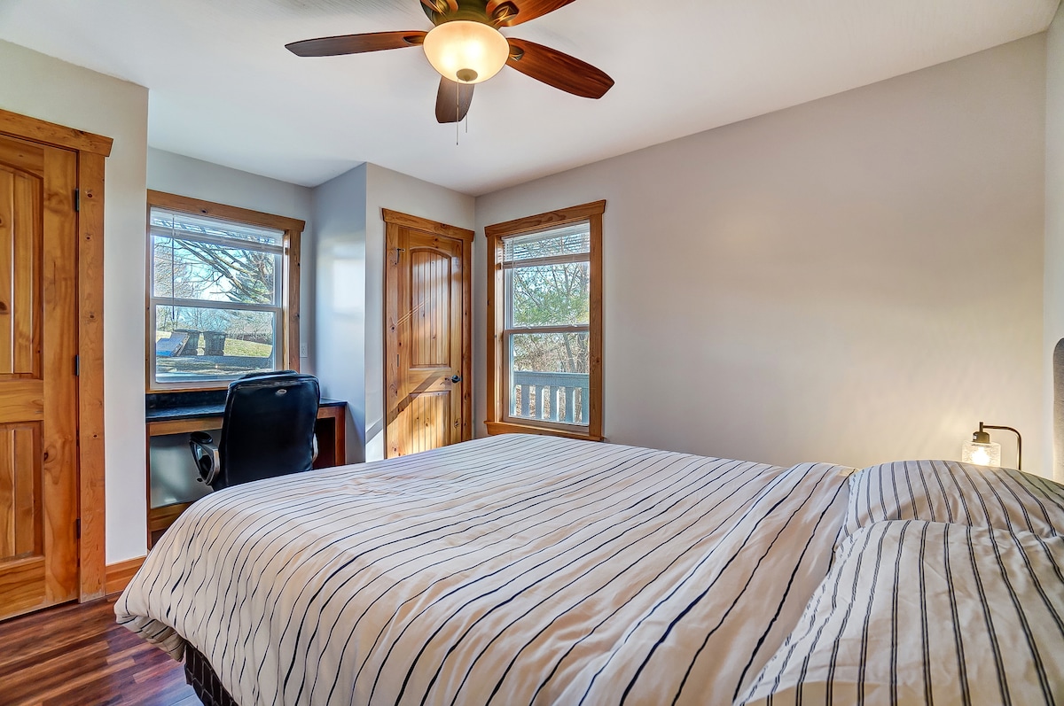 Bedroom 1 on main floor with a king bed and dedicated workspace.