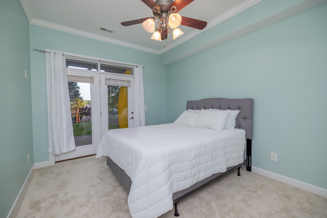 Bedroom 5,  to the left downstairs.  Queen bed, night stand, ceiling fan, access to bath.  Access to outside area, large closet

