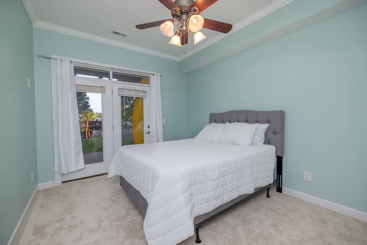 Bedroom 5,  to the left downstairs.  Queen bed, night stand, ceiling fan, access to bath.  Access to outside area, large closet

