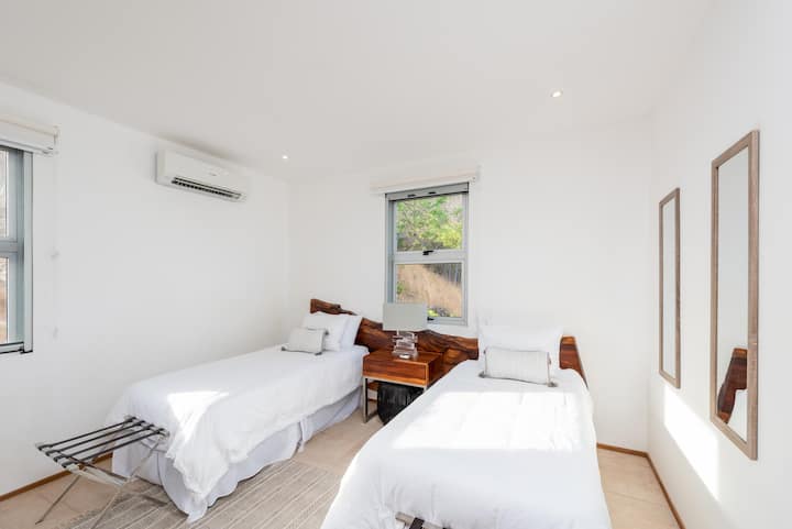 2 single beds or can be pushed together to make a king. Featuring ceiling fan, ac unit, and en-suite bathroom.