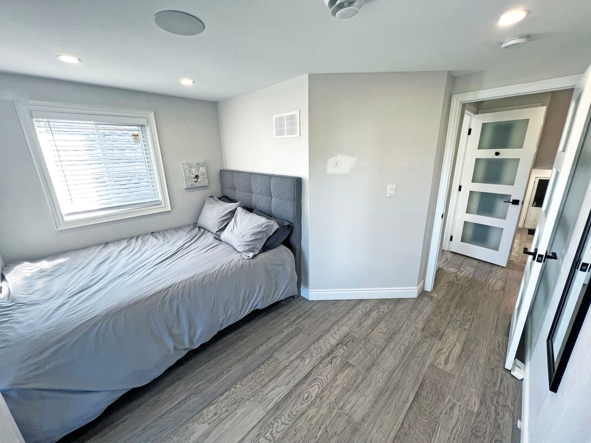 Upstairs Bedroom 1 offers a cozy and inviting space with a comfortable bed and stylish decor. Perfect for unwinding, this room provides a peaceful retreat after a day of exploring or relaxing.