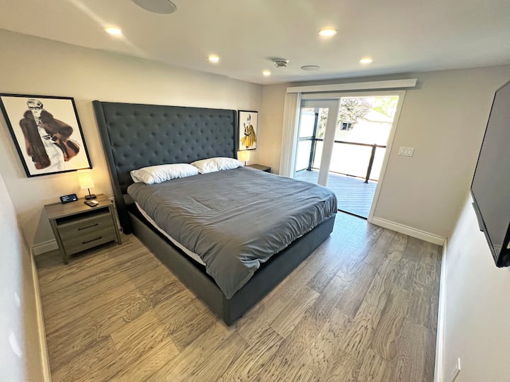 Unwind in the spacious master bedroom featuring a luxurious king-size bed and direct access to an open balcony. Perfect for enjoying your morning coffee or evening breeze in serene comfort.